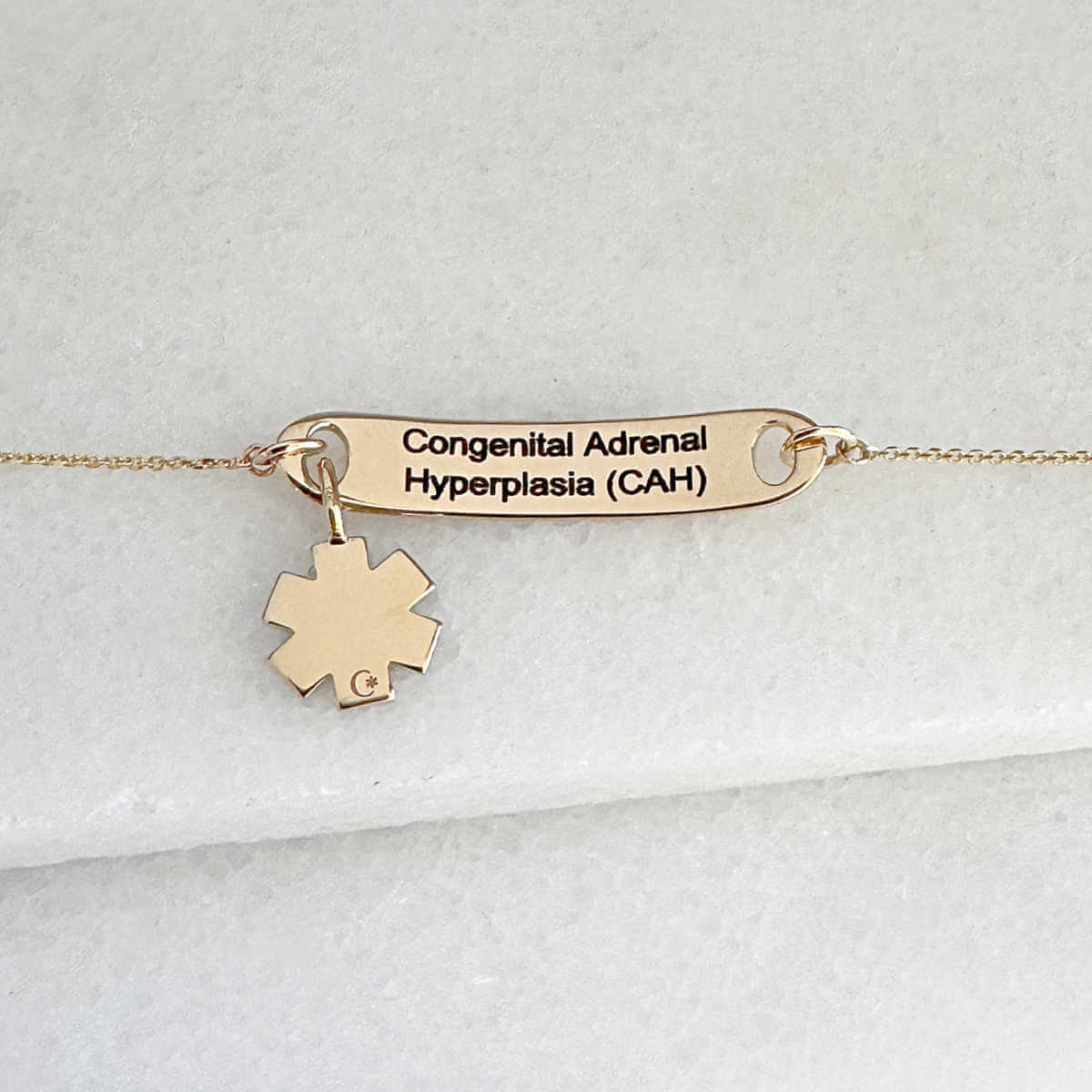Gold medical ID tag bracelet or necklace with personalized engraving shown on the inside