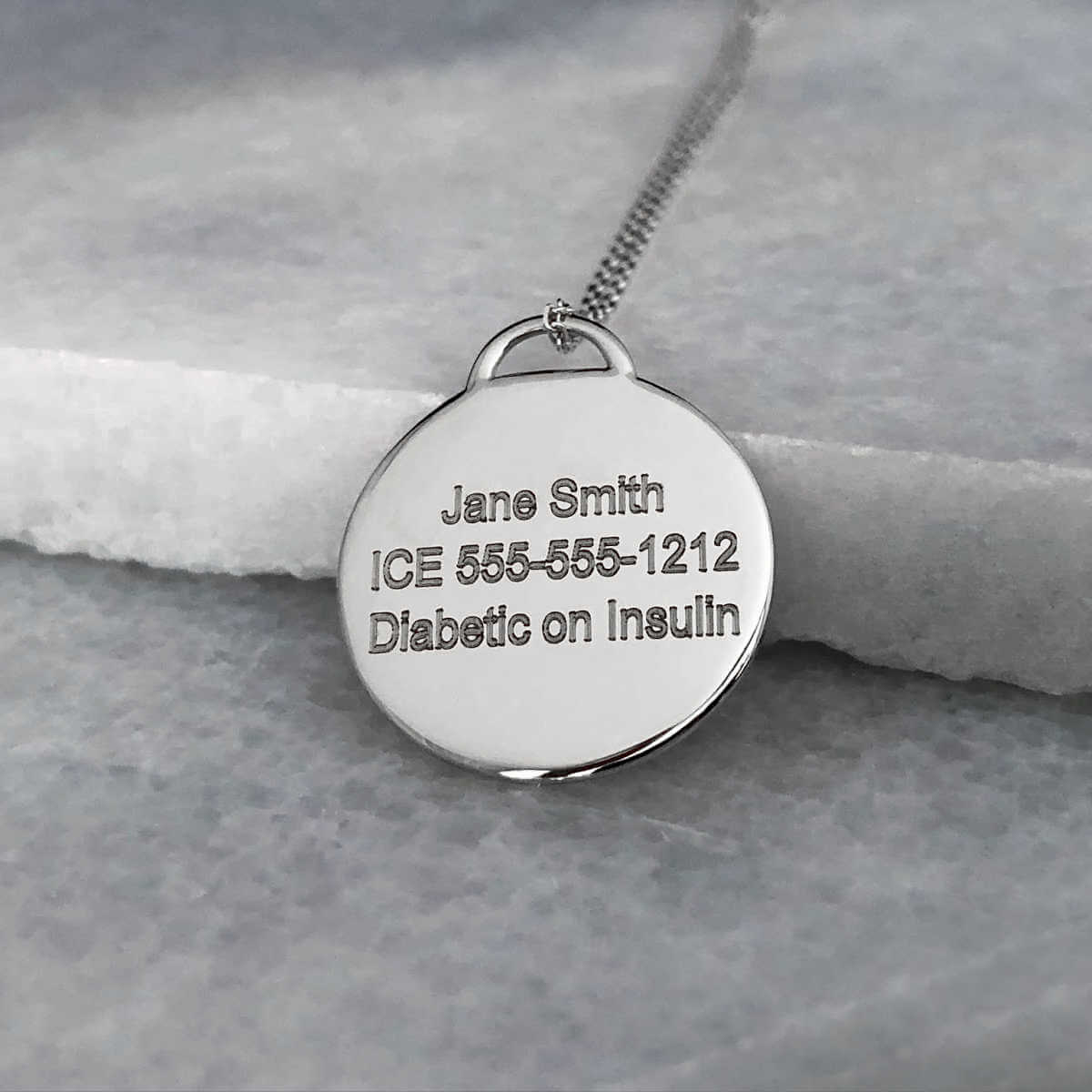 White Gold Medical ID with personalized engraving shown on the back side