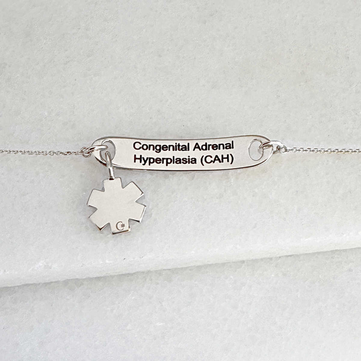White gold medical ID tag bracelet or necklace with personalized engraving shown on the inside