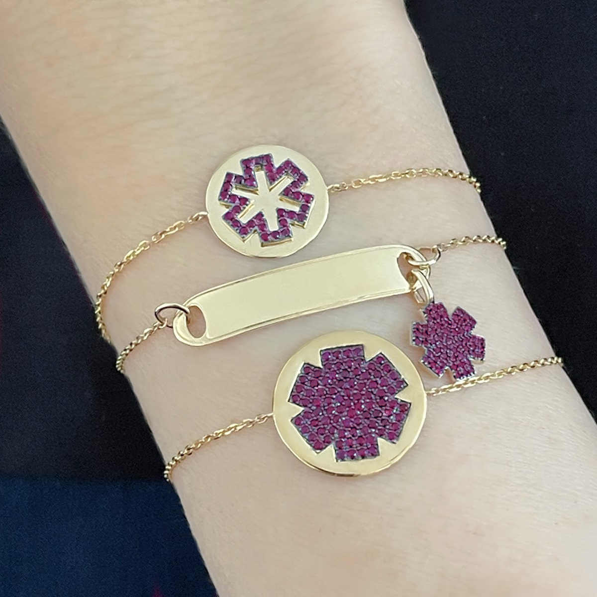 Woman Wearing 3 Medical ID Bracelets. Custom Engraved 14k Gold Medical Alert Jewelry with Rubies