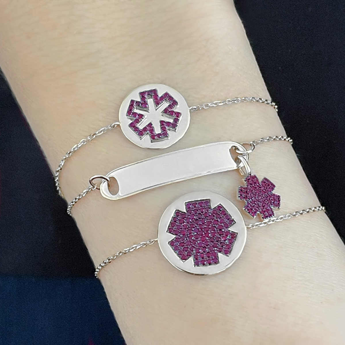 Woman Wearing 3 Medical ID Bracelets. Custom Engraved 14k White Gold Medical Alert Jewelry with Rubies