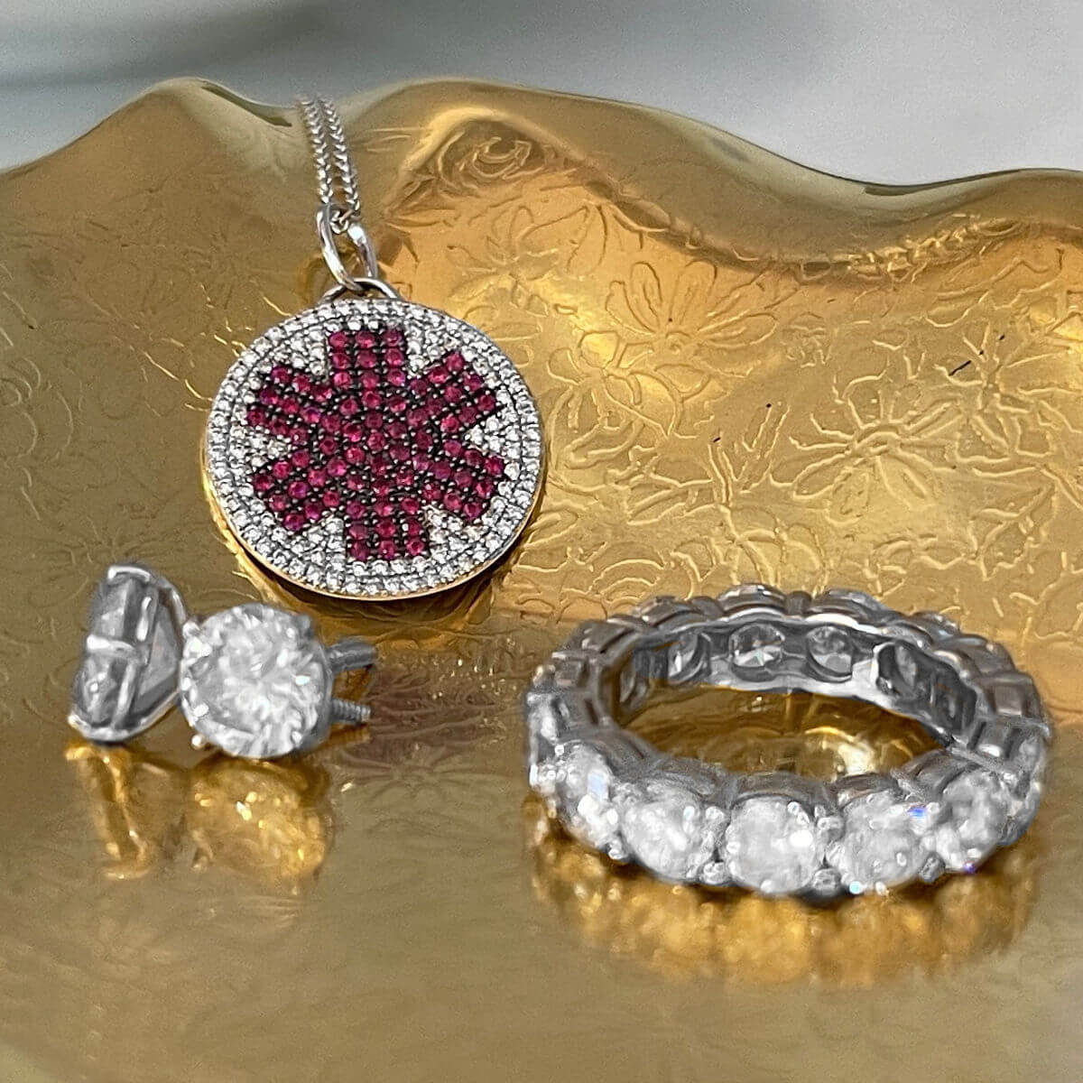 Diamond medical ID necklace in gold jewelry tray with woman's diamond jewelry