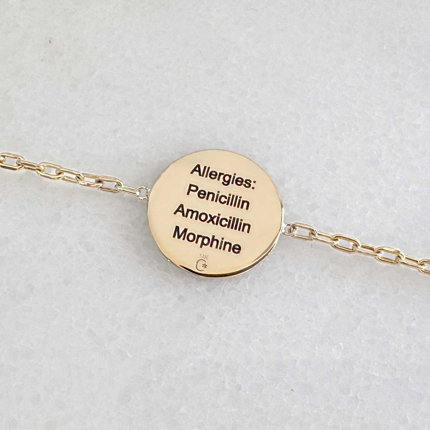 Gold Medical ID bracelet with personalized engraving shown on the back side