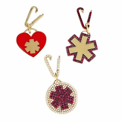 Gold medical ID charms with diamonds, enamel, & rubies, styled with matching charm holders