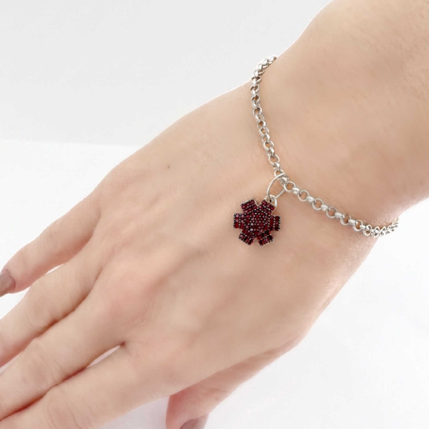 Woman wearing medical ID bracelet in 925 sterling silver and garnet with personalized engraving