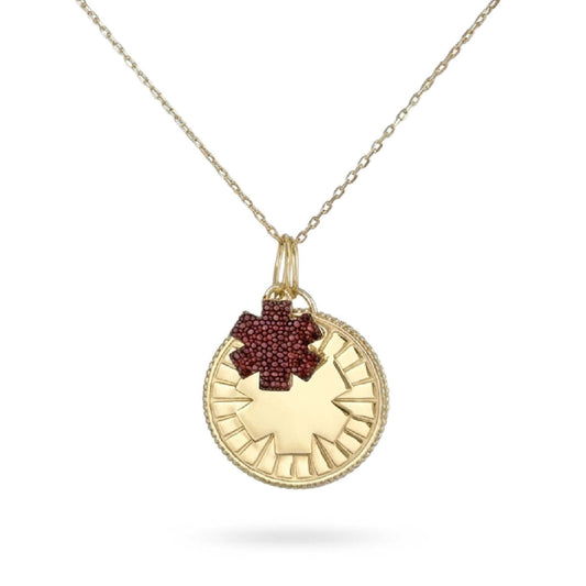 A gold plated medical ID medallion necklace with a garnet jeweled star of life accent charm attached to a silver cable chain.
