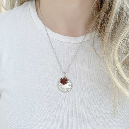 Woman wearing medical id necklace with engraved sterling silver and garnet medallion charms