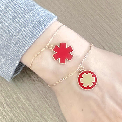 Woman Wearing 2 Medical ID Charm Bracelets. Engraved 14k Gold Medical Alert Jewelry with Red Enamel Star of Life
