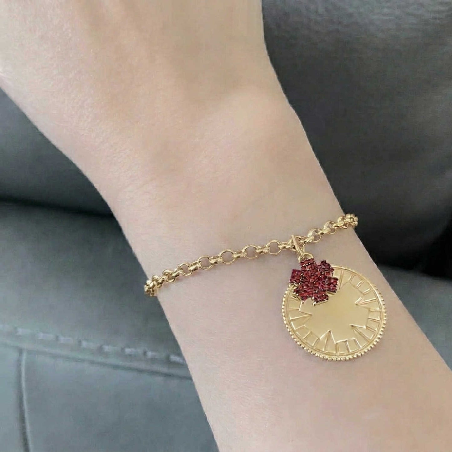 Woman wearing medical ID bracelet in gold plated sterling silver and garnet with personalized engraving