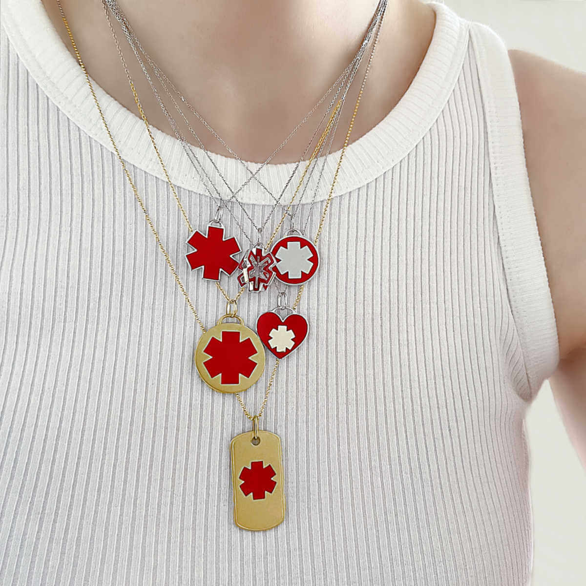 Woman Wearing Medical ID Charm Necklaces. Engraved 14k Gold Medical Alert Jewelry with Red Enamel Star of Life