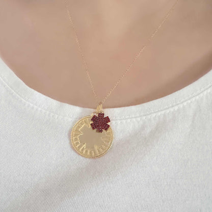 Woman Wearing Medical ID Medallion Necklace. Custom Engraved Gold Plated Medical Alert Jewelry with Garnets
