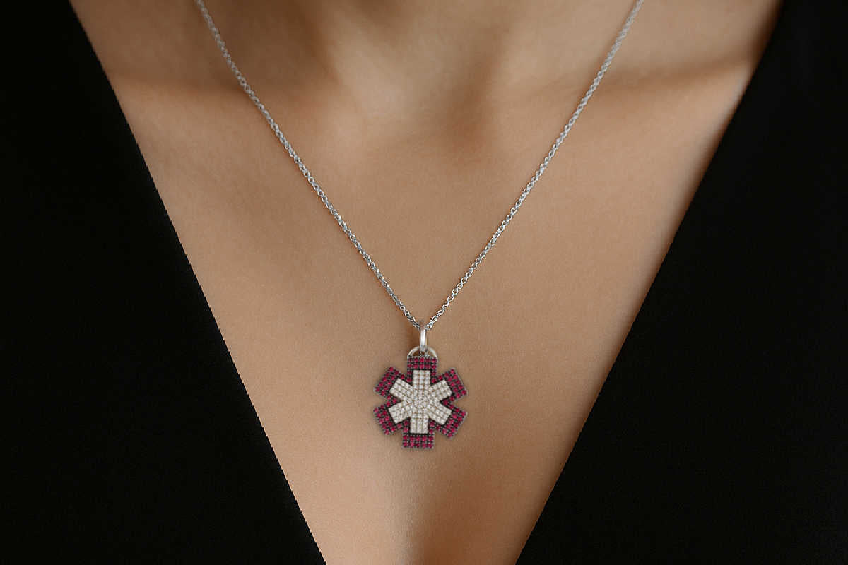 Woman wearing necklace with a diamond star of life pendant on a black background