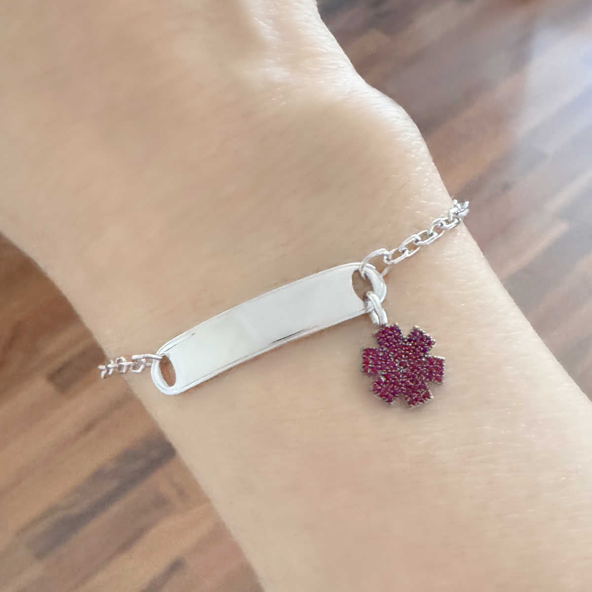 Woman Wearing White Gold Medical ID Tag Bracelet with Ruby Star of Life Charm, Personalized Engraving