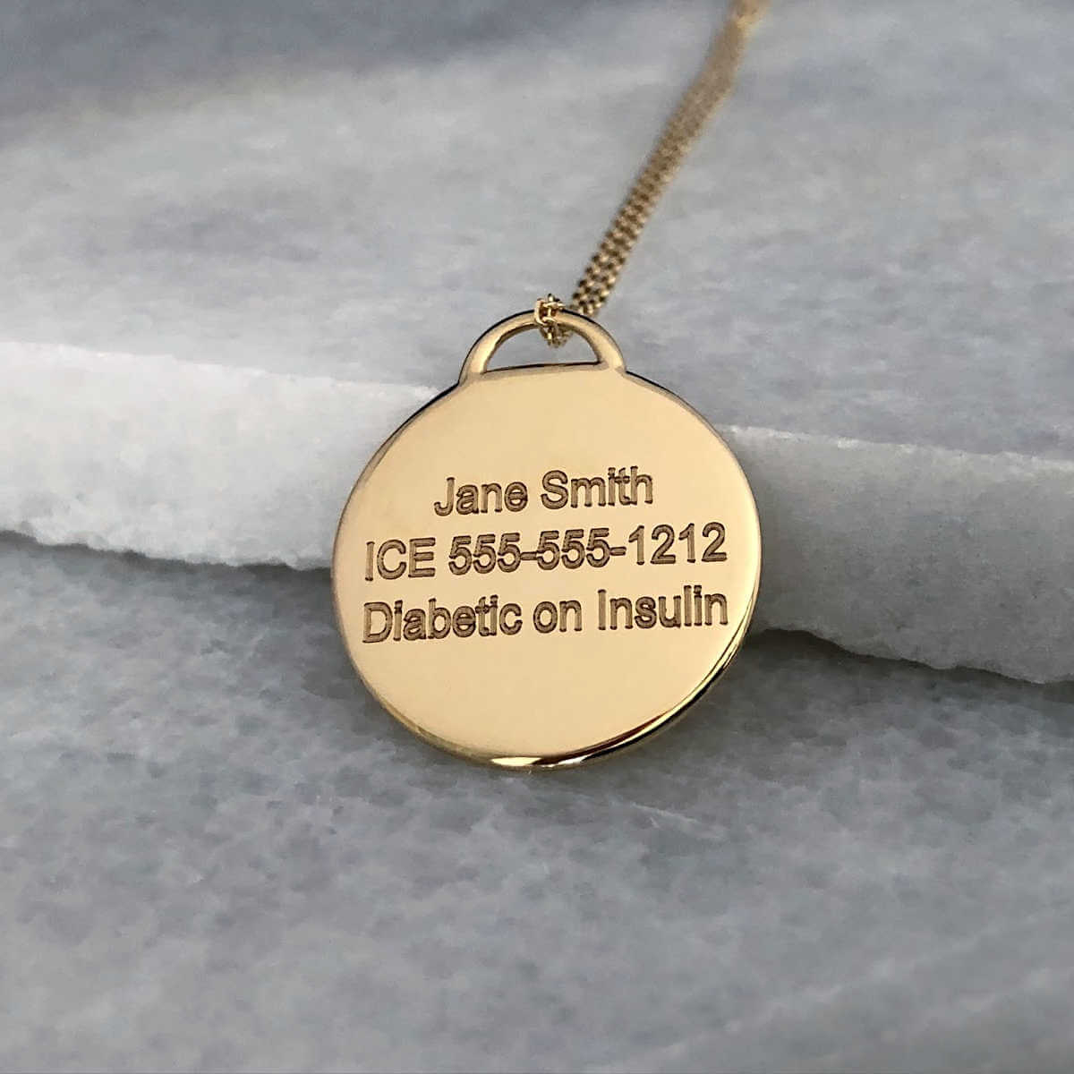 Gold Medical ID with personalized engraving shown on the back side