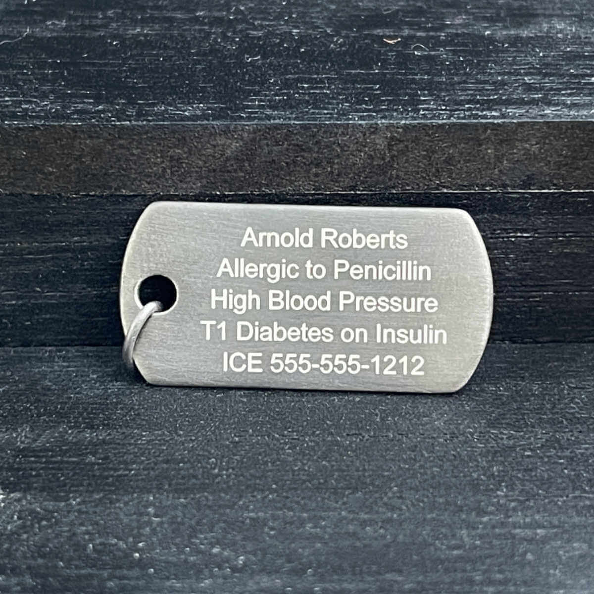 White gold medical ID dog tag with personalized engraving shown on the back side