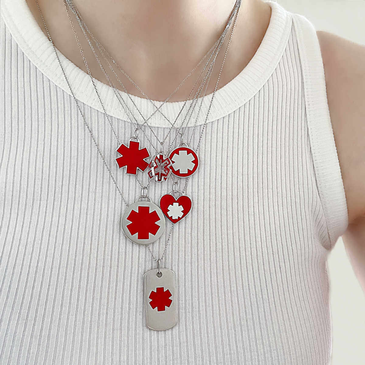 Woman wearing medical ID charm necklaces, white gold medical alert jewelry with  personalized engraving